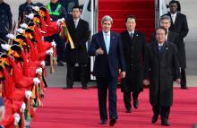U.S. Secretary of State John Kerry (L) walks with South Korean Deputy Foreign Minister Lee Kyung-soo (R) upon his arrival at a military airport in Seongnam, south of Seoul