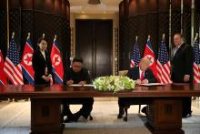 U.S. President Donald Trump and North Korea's leader Kim Jong Un sign documents that acknowledge the progress of the talks and pledge to keep momentum going, after their summit at the Capella Hotel on Sentosa island in Singapore, June 12, 2018. PHOTO BY REUTERS/Jonathan Ernst