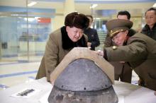 North Korean leader Kim Jong Un looks at a rocket warhead tip after a simulated test of atmospheric re-entry of a ballistic missile, at an unidentified location in this undated file photo released by North Korea's Korean Central News Agency (KCNA) in Pyongyang, March 15, 2016. PHOTO BY REUTERS/KCNA