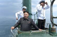 Kim Jong Un stands on the conning tower of a submarine during his inspection of the Korean People's Army Naval Unit 167 in this undated photo released June 16, 2014. PHOTO BY REUTERS/KCNA