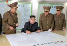 North Korean leader Kim Jong Un reviews the plan for landing missiles near the U.S. territory of Guam in this undated still photo taken from video provided by KRT. PHOTO BY REUTERS/KRT 