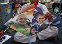An employee ties threads on a kite, with portraits of Indian Prime Minister Narendra Modi (L) and U.S. President Barack Obama, ahead of Obama's visit, in Mumbai, January 23, 2015. PHOTO BY REUTERS/Danish Siddiqui