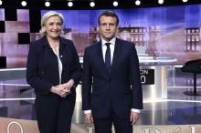 Candidates for the 2017 presidential election, Emmanuel Macron (R), head of the political movement En Marche !, or Onwards !, and Marine Le Pen, of the French National Front (FN) party, near Paris, France, May 3, 2017. PHOTO BY REUTERS/Eric Feferberg