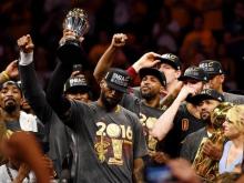 Cleveland Cavaliers forward LeBron James (23) celebrates with the Bill Russell MVP Trophy after beating the Golden State Warriors in game seven of the NBA Finals at Oracle Arena. PHOTO BY REUTERS/Bob Donnan-USA TODAY Sports
