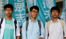 Student leaders (from L) Joshua Wong, Nathan Law and Alex Chow pose before a verdict, on charges of inciting and participating in an illegal assembly in 2014 which led to the "Occupy Central" pro-democracy movement, outside a court in Hong Kong, July 21, 2016. PHOTO BY REUTERS/Bobby Yip