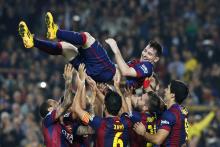 Barcelona's Lionel Messi celebrates his second goal with teammates during their Spanish first division soccer match against Sevilla at Nou Camp stadium in Barcelona, November 22, 2014. PHOTO BY REUTERS/Gustau Nacarino