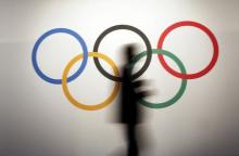 A man walks past the Olympic rings before the opening of the 127th International Olympic Committee (IOC) session in Monaco, December 8, 2014. PHOTO BY REUTERS/Eric Gaillard
