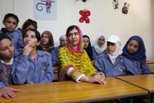 Nobel Peace Prize laureate Malala Yousafzai (C) sits with girls inside a classroom at a school for Syrian refugee girls, built by the NGO Kayany Foundation, in Lebanon's Bekaa Valley, July 12, 2015. PHOTO BY REUTERS/Jamal Saidi