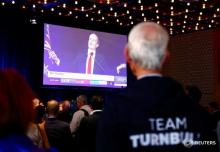 A supporter of Australian Prime Minister Malcolm Turnbull watches as Labor Party leader Bill Shorten speaks on a television screen during an official function for the Liberal Party during the Australian general election in Sydney, Australia, July 2, 2016. PHOTO BY REUTERS/David Gray