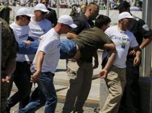 A man who disturbed security during a ceremony marking the 20th anniversary of the Srebrenica massacre, is carried away by security officers in Potocari, near Srebenica, Bosnia and Herzegovina, July 11, 2015. PHOTO BY REUTERS/Antonio Bronic