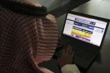 A Saudi man explores a website on his laptop in Riyadh