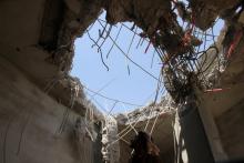A man looks at a hole caused by a Saudi-led air strike on a building in the northwestern city of Saada, Yemen, September 10, 2016. PHOTO BY REUTERS/Naif Rahma