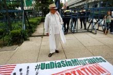 A man stands in front a banner reading "A day without migrants" during a protest outside the U.S Embassy in Mexico City, Mexico, September 5, 2017. PHOTO BY REUTERS/Alejandro Cegarra