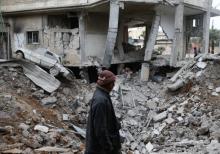 A man is seen near rubble of damaged buildings after an airstrike on the Eastern Ghouta town of Misraba, Syria, January 4, 2018. PHOTO BY REUTERS/Bassam Khabieh