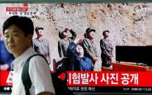 A man walks past a TV broadcasting still photographs released by North Korea's state-run television KRT of North Korea's Hwasong-14 missile, a new intercontinental ballistic missile, which they said was successfully tested, at a railway station in Seoul, South Korea, July 4, 2017. PHOTO BY REUTERS/Kim Hong-Ji