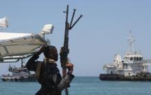 A maritime policeman on a tag-boat guards oil tanker Aris-13, which was released by pirates, as it sails to dock on the shores of the Gulf of Aden in the city of Bosasso, northern Somalia's semi-autonomous region of Puntland, March 19, 2017. REUTERS/Abdiqani Hassan