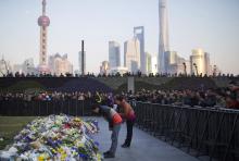 People bow during a memorial ceremony for people who were killed in a stampede incident during a New Year's celebration on the Bund, in Shanghai January 2, 2015. PHOTO BY REUTERS/Aly Song