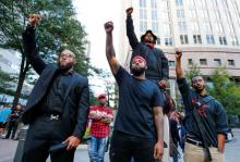 People gather at the intersection of Trade and Tryon Streets in uptown Charlotte, NC to protest the police shooting of Keith Scott, in Charlotte, North Carolina, U.S., September 21, 2016. PHOTO BY REUTERS/Jason Miczek
