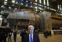 Britain's Defence Secretary Michael Fallon stands in front of HMS Anson, under construction, at BAE Systems in Barrow-In-Furness, Britain, October 5, 2016. PHOTO BY REUTERS/Phil Noble