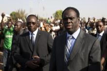 Burkina Faso President Michel Kafondo (R) and Prime Minister Isaac Zida (L) arrive at a memorial service for six people who died during the recent popular uprising in Ouagadougou, December 2, 2014. PHOTO BY REUTERS/Joe Penney