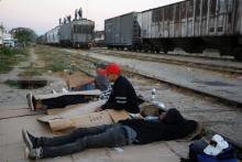 Central American migrants rest next to the train tracks while waiting for the freight train "La Bestia", or the Beast, to travel to north Mexico to reach and cross the U.S. border, in Arriaga in the state of Chiapas, January 10, 2012. PHOTO BY REUTERS/Jorge Luis Plata