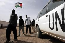 African would-be immigrants walk past a UN vehicle in the Bir Lahlu refugee camp in the Western Sahara. PHOTO BY REUTERS/Juan Medina