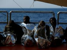 Exhausted migrants rest on the Malta-based NGO Migrant Offshore Aid Station (MOAS) ship Phoenix after being rescued. PHOTO BY REUTERS/Darrin Zammit Lupi