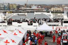 Migrants disembark Italian coast guard vessel "Diciotti" as they arrive at the port of Catania, Italy, June 13, 2018. PHOTO BY REUTERS/Antonio Parrinello
