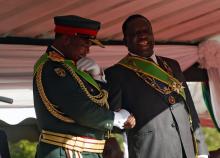 Zimbabwe's President Emmerson Mnangagwa (R) shares a joke with retired Commander of Zimbabwe Defence Forces (ZDF) General Constatino Chiwenga at a farewell army parade in Harare, Zimbabwe, December 19, 2017. PHOTO BY REUTERS/Philimon Bulawayo