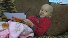 Syrian Refugee Mohammad Alkhaled who suffers from Ewing Sarcoma and would need expensive chemotherapy sessions, lies by his father Jihad Al-Khaled who speaks to a reporter in their home in Amman, Jordan, January 29, 2017. PHOTO BY REUTERS Video News