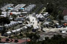 People make their way inside the Moria holding centre for refugees and migrants, on the Greek island of Lesbos, April 15, 2016. PHOTO BY REUTERS/Alkis Konstantinidis