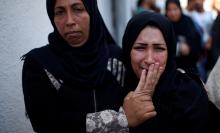 The mother of 8-month-old Palestinian infant Laila al-Ghandour, who died after inhaling tear gas during a protest against U.S. embassy move to Jerusalem at the Israel-Gaza border, mourns during her funeral in Gaza City, May 15, 2018. PHOTO BY REUTERS/Mohammed Salem