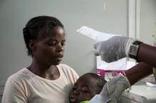 A mother holds her son suffering from yellow fever as she waits for a prescription at a hospital in Luanda?, Angola, March 15, 2016. PHOTO BY REUTERS/Herculano Coroado