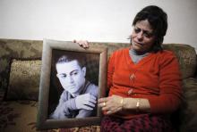 The mother of Muhammad Musallam, an Israeli Arab held by Islamic State in Syria as an alleged spy, weeps as she holds his photograph in her East Jerusalem home, February 12, 2015. PHOTO BY REUTERS/Ammar Awad