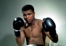 Muhammad Ali poses with gloves in this undated portrait. PHOTO BY REUTERS/Sporting Pictures