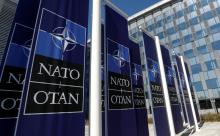 Banners displaying the NATO logo are placed at the entrance of new NATO headquarters during the move to the new building, in Brussels, Belgium, April 19, 2018. PHOTO BY REUTERS/Yves Herman