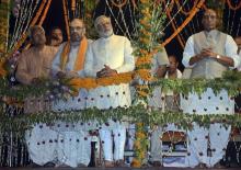 Hindu nationalist Narendra Modi (C), India's prime minister-elect from the Bharatiya Janata Party (BJP), watches a ritual known as "Aarti" during evening prayers on the banks of river Ganges at Varanasi, in the northern Indian state of Uttar Pradesh
