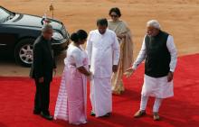 Indian Prime Minister Narendra Modi (R) gestures to Sri Lanka's President Mithripala Sirisena's wife Jayanthi Sirisena (2nd L) as India's President Pranab Mukherjee (L) looks on during Sirisena's ceremonial reception at the forecourt of India's Rashtrapati Bhavan presidential palace in New Delhi, February 16, 2015. PHOTO BY REUTERS/Adnan Abidi