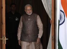 India's Prime Minister Narendra Modi comes out of a meeting room to receive his Bhutanese counterpart Tshering Tobgay before the start of their bilateral meeting in New Delhi