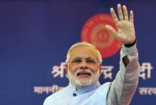 Prime Minister Narendra Modi waves to a crowd at a gathering after inaugurating a train on a new stretch of railway to the town of Katra, northwest of Jammu