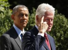 U.S. President Barack Obama (L) listens to former president Bill Clinton during an event marking the 20th anniversary of the national service program AmeriCorps at the White House in Washington, September 12, 2014. PHOTO BY REUTERS/Kevin Lamarque