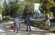 Officers of a Russian special task police unit stand guard outside a nursery school, as part of tightened security measures following an attack on a local college, in the city of Kerch, Crimea, October 18, 2018. PHOTO BY REUTERS/Pavel Rebrov