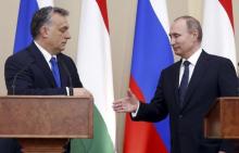 Russian President Vladimir Putin (R) and Hungarian Prime Minister Viktor Orban shake hands during a joint news conference following their talks at the Novo-Ogaryovo state residence outside Moscow, Russia, February 17, 2016. PHOTO BY REUTERS/Maxim Shipenkov