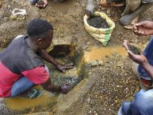 An artisanal miner washes tin ore before it is bagged up and weighed, ready to be transported to the nearest major town for export in the Kalimbi tin mine near the small town of Nyabibwe. PHOTO BY REUTERS/Jonny Hogg