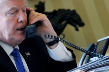 U.S. President Donald Trump speaks by phone with Russia's President Vladimir Putin in the Oval Office at the White House in Washington, U.S., January 28, 2017. PHOTO BY REUTERS/Jonathan Ernst