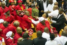 Members of Julius Malema's Economic Freedom Fighters (EFF) (in red) clash with security officials after being ordered out of the chamber during President Jacob Zuma's State of the Nation address in Cape Town, February 12, 2015. PHOTO BY REUTERS/Rodger Bosch