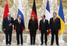 Belarus' President Alexander Lukashenko (L), Russia's President Vladimir Putin (2nd L), Ukraine's President Petro Poroshenko (R), Germany's Chancellor Angela Merkel (C) and France's President Francois Hollande pose for a family photo during peace talks in Minsk, February 11, 2015. PHOTO BY REUTERS/Grigory Dukor