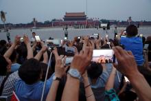 People film with their phones and cameras during a flag-raising ceremony at the Tiananmen Square in Beijing, China, June 4, 2016. PHOTO BY REUTERS/Damir Sagolj