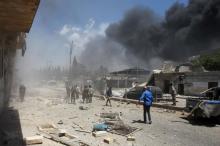 People inspect a site hit by airstrikes in Idlib city, Syria, June 12, 2016. PHOTO BY REUTERS/Ammar Abdullah