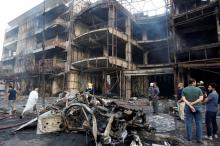 People gather at the site of a suicide car bomb in the Karrada shopping area, in Baghdad, Iraq, July 3, 2016. PHOTO BY REUTERS/Khalid al Mousily